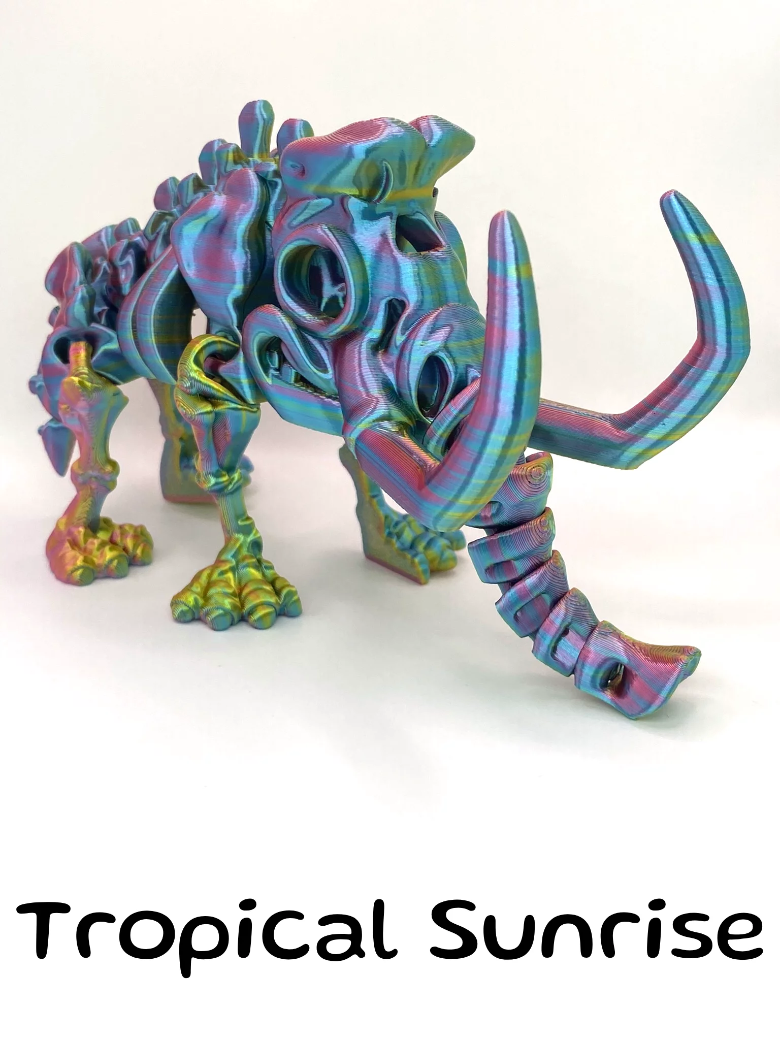 A light rainbow Metallic Skeleton Mammoth Fidget Factory Toy, the colours look like an oil spill
