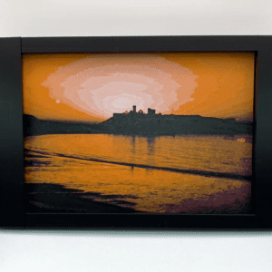 A filament painting of Peel Castle, with the setting sun luminating the sky and reflecting off the water